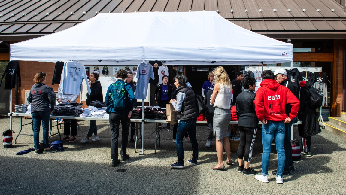 Visitors browsing the merchandise tent at the regatta