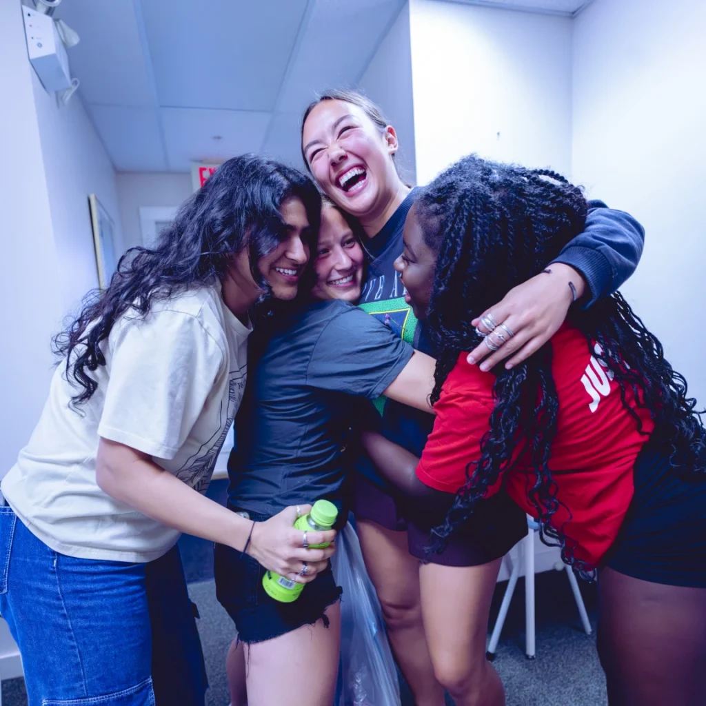 Four students in a group huge laughing
