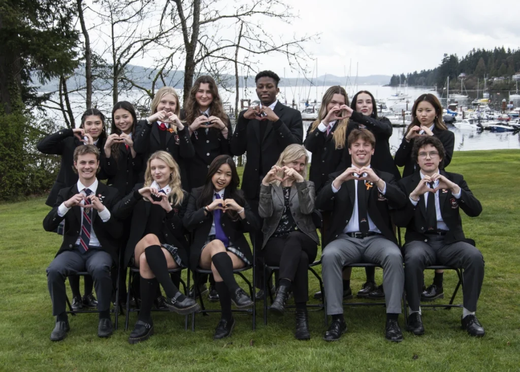 The B-Well wellness group making heart shapes with their hands