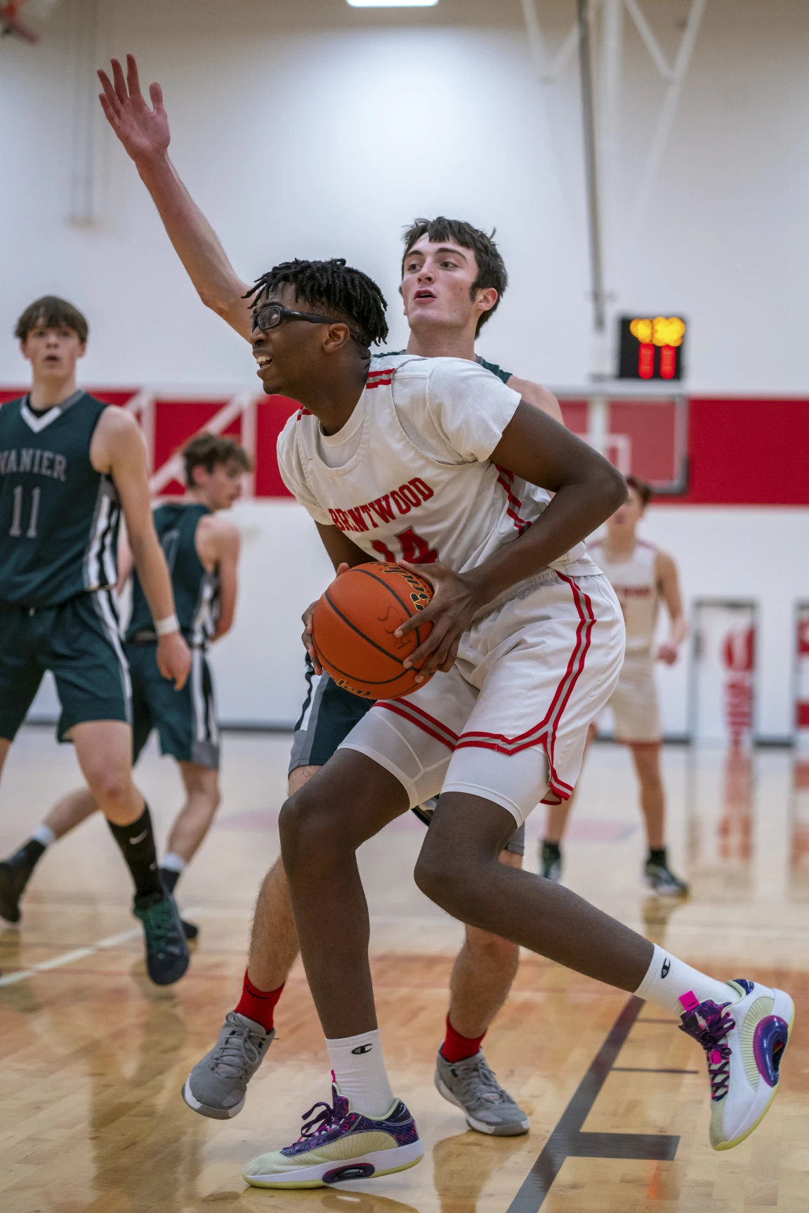 A private school basketball player preparing for a layup