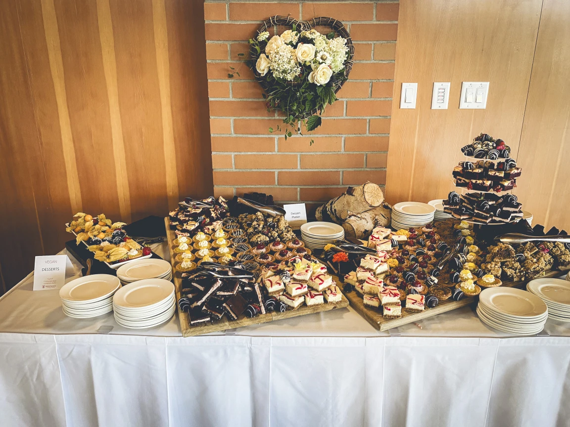 A selection of delectable desserts,piled high and with white rose bouquet