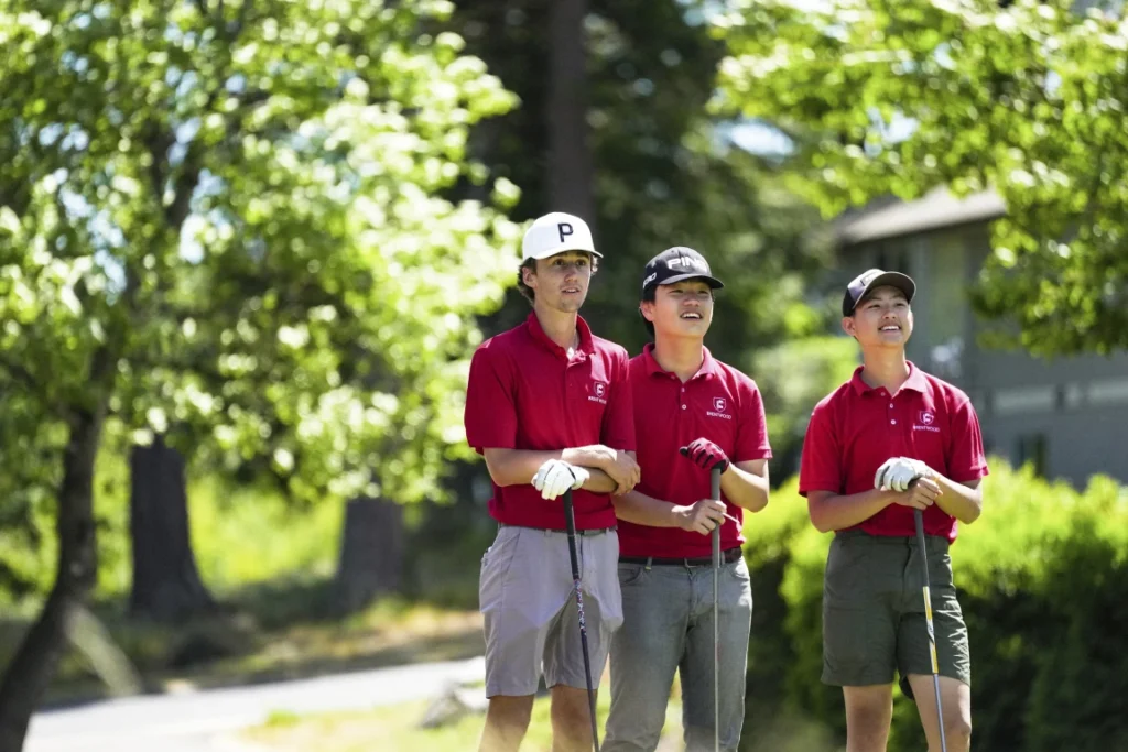 Three members of the golf team on the course