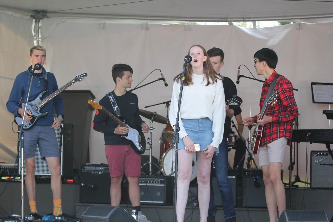 A student band performing live under a tent at the regatta