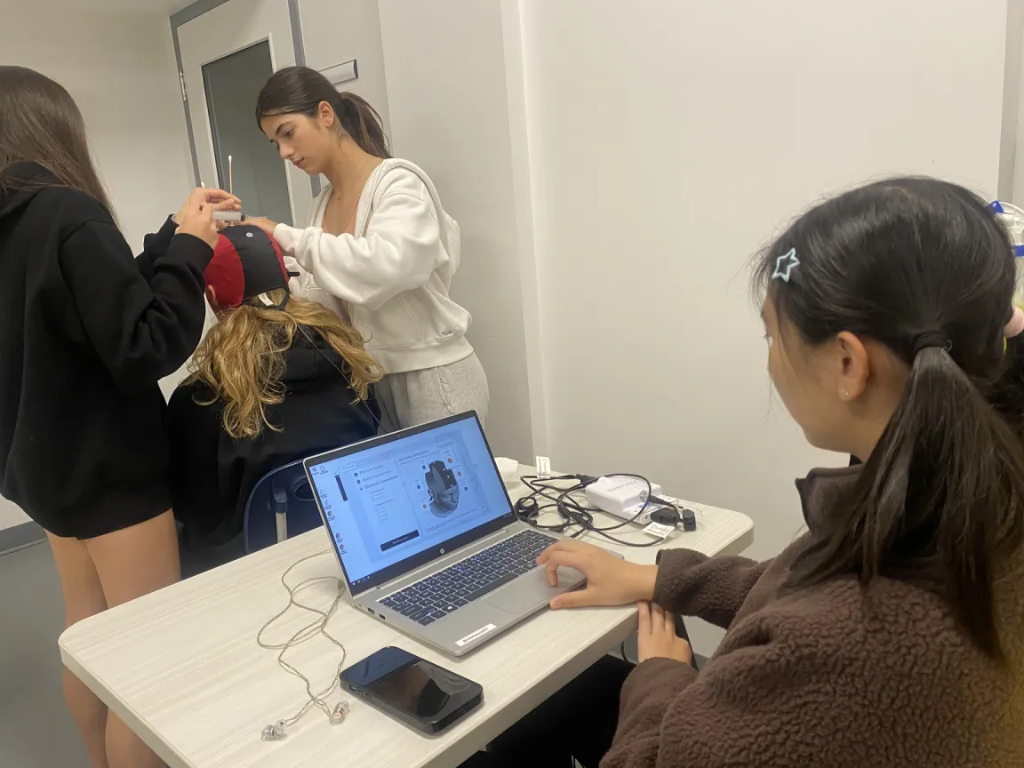 Brentwood College School student neuroscientists scan and monitor the cognitive responses of a volunteer student-athlete .