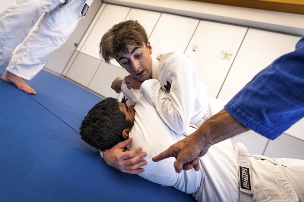 Jiu-Jitsu students working on a technique on the mats