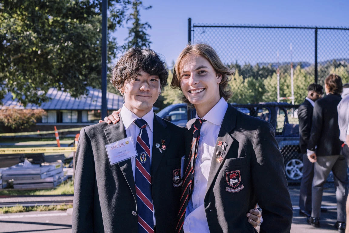 Two private school students in uniform smiling