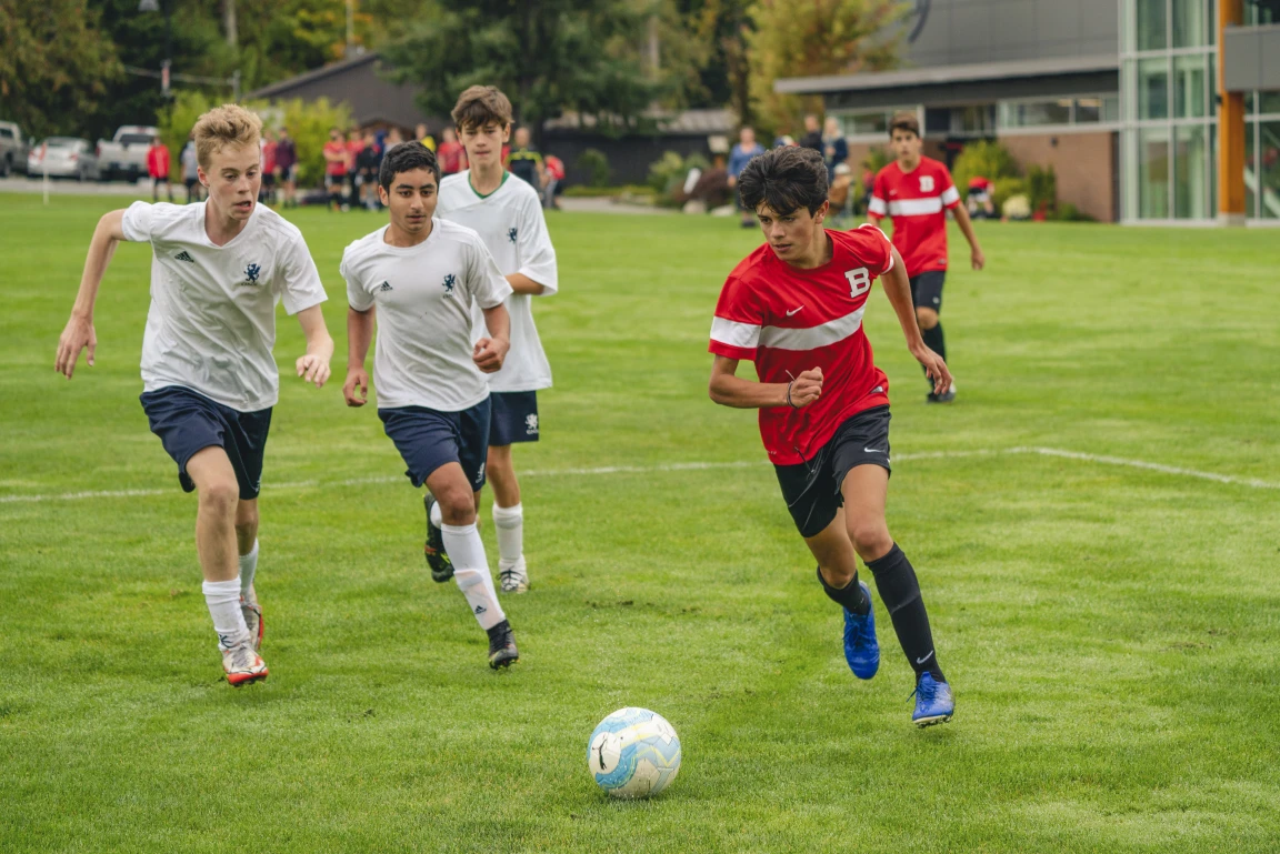 A player tracking down the ball in the eighteen yard box