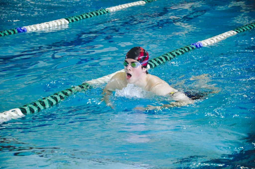A student working on their technique in the pool