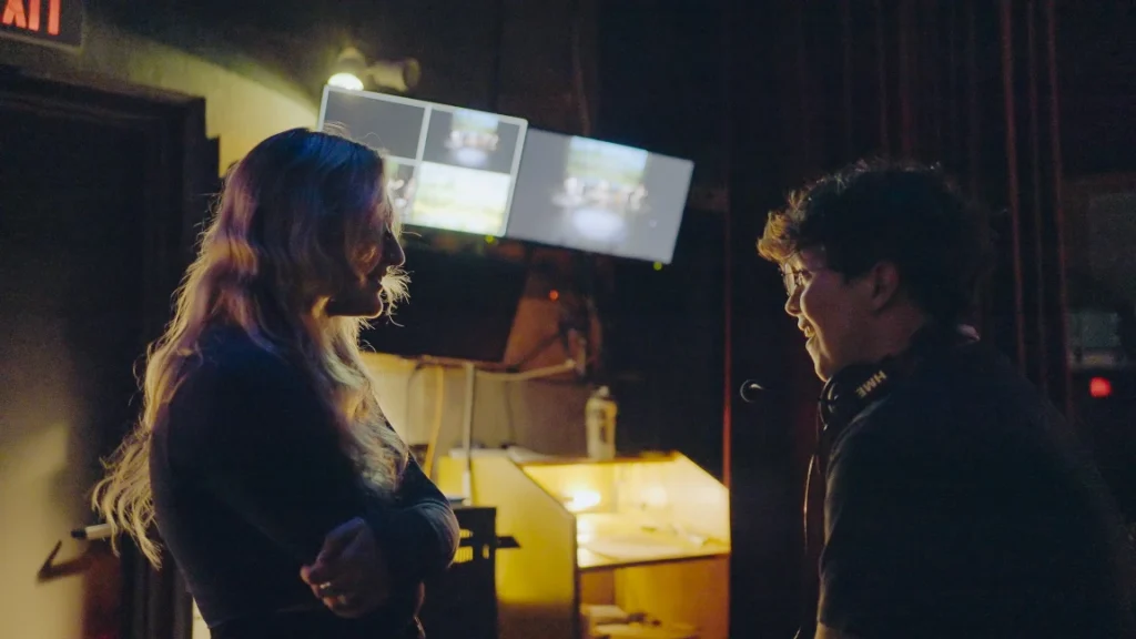 Two tech crew students talking backstage