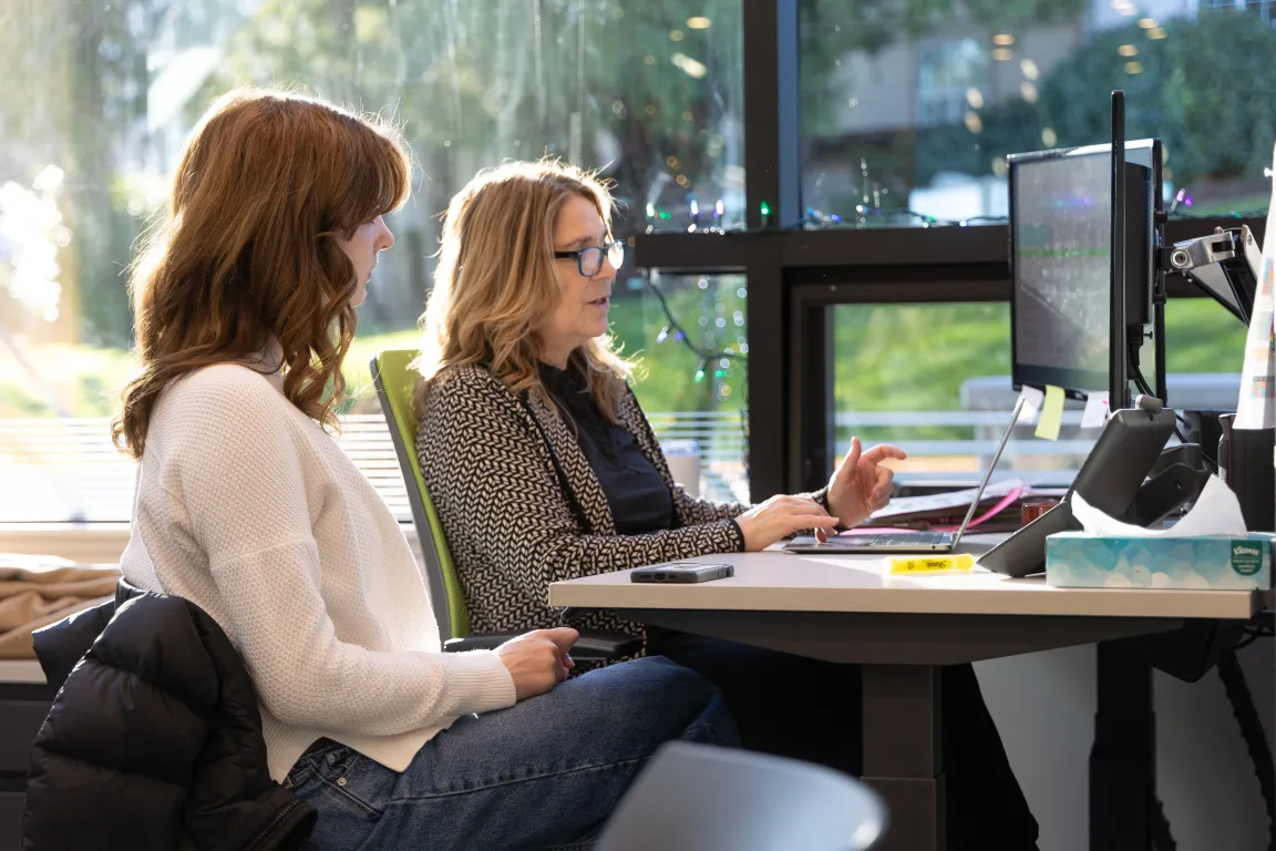 A student meeting with a university counsellor at a desk