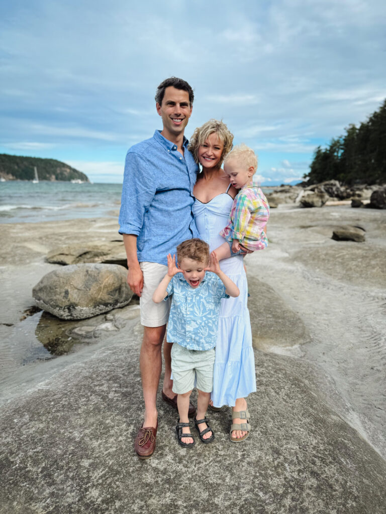 Alex Richards with her family on a rocky shoreline